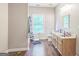Bathroom with hardwood floor, a single sink vanity, toilet, and window at 871 Rocky Creek Rd, Hampton, GA 30228