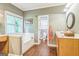 Bathroom featuring a bathtub, makeup vanity, and wood-look floor at 871 Rocky Creek Rd, Hampton, GA 30228