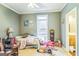 A simple carpeted bedroom featuring a window and natural light at 871 Rocky Creek Rd, Hampton, GA 30228