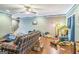 Cozy living room featuring a plaid sofa and hardwood floors, with abundant natural light at 871 Rocky Creek Rd, Hampton, GA 30228