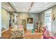 Comfortable living room with wood floors, a coffered ceiling, and natural light at 871 Rocky Creek Rd, Hampton, GA 30228