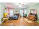 Spacious main bedroom with hardwood floors, ceiling fan, and dual windows at 871 Rocky Creek Rd, Hampton, GA 30228