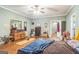 Bright main bedroom with hardwood floors and art at 871 Rocky Creek Rd, Hampton, GA 30228