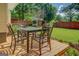 Outdoor back deck with dining set and a view of the spacious, well-manicured lawn and backyard at 3170 Butler Se Ave, Covington, GA 30014