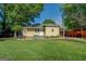 Back exterior view featuring a patio, lush lawn, and a detached storage shed, perfect for outdoor living at 3170 Butler Se Ave, Covington, GA 30014