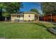 Back exterior showcasing a patio, spacious lawn, and covered outdoor area, perfect for relaxing at 3170 Butler Se Ave, Covington, GA 30014