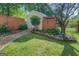 A peaceful backyard with lush lawn, landscaped garden, and a storage shed at 3170 Butler Se Ave, Covington, GA 30014