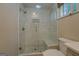 Bright bathroom with a glass enclosed shower, marble-style tiling and rain shower head at 3170 Butler Se Ave, Covington, GA 30014