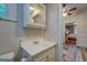 Bathroom with white vanity, fixtures, medicine cabinet and views to the bedroom at 3170 Butler Se Ave, Covington, GA 30014