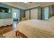 Well-lit bedroom with white bedspread, ensuite bath access, and wood flooring at 3170 Butler Se Ave, Covington, GA 30014