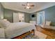 Cozy bedroom with a bed, rocking chair, white dresser, and wood flooring at 3170 Butler Se Ave, Covington, GA 30014