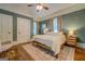Calming bedroom with a plush bed, wood floors, and natural light from the windows at 3170 Butler Se Ave, Covington, GA 30014