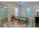 Cozy bedroom with wooden floors, a patterned rug and access to a bathroom with glass enclosed shower at 3170 Butler Se Ave, Covington, GA 30014
