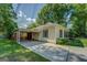 Side view of a one-story home with a fenced in carport featuring ample parking and potential for outdoor storage at 3170 Butler Se Ave, Covington, GA 30014