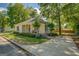 Well-kept home featuring neutral siding, covered front porch, established landscaping and long driveway leading to backyard gate at 3170 Butler Se Ave, Covington, GA 30014