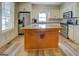 This bright kitchen is complete with stainless appliances, granite counters and island at 3170 Butler Se Ave, Covington, GA 30014