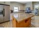 Bright kitchen with stainless refrigerator, appliances and island at 3170 Butler Se Ave, Covington, GA 30014