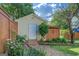 Outdoor shed surrounded by landscaped garden beds and a stone pathway, enhancing the backyard's appeal at 3170 Butler Se Ave, Covington, GA 30014