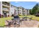 Exterior view of a building showcasing a patio with outdoor seating and a grill in a well-maintained backyard at 705 Berry Ct, Villa Rica, GA 30180