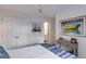 Bright bedroom with white walls, ceiling fan, closet doors, and artwork depicting colorful sailboats and a boat at 705 Berry Ct, Villa Rica, GA 30180