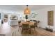 Dining room with a round woven dining table and chairs, and access to the backyard through large windows, showcasing the living area at 705 Berry Ct, Villa Rica, GA 30180