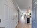Inviting entryway with wood floors flowing into a bright, open living space with modern kitchen and a glimpse of the backyard at 705 Berry Ct, Villa Rica, GA 30180