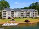 Beautiful condo community on the lake featuring manicured lawn and private dock with lounge chairs at 705 Berry Ct, Villa Rica, GA 30180