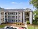 A beautiful three-story condo featuring multiple balconies and lovely landscaping at 705 Berry Ct, Villa Rica, GA 30180