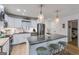 Charming kitchen with a large island, barstool seating, stainless steel appliances, granite countertops, and ample natural light at 705 Berry Ct, Villa Rica, GA 30180