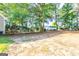 A spacious backyard with dirt ground and treeline near a house at 8500 Bowen Ct, Jonesboro, GA 30238