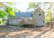 A spacious backyard featuring a well-maintained lawn and a wooden back deck at 8500 Bowen Ct, Jonesboro, GA 30238