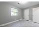 Bedroom features modern gray walls and light wood look floors with a window for natural light at 8500 Bowen Ct, Jonesboro, GA 30238
