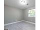 Bedroom features modern gray walls and light wood look floors with a window for natural light at 8500 Bowen Ct, Jonesboro, GA 30238