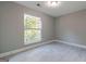 A spacious bedroom with gray walls, light-colored floors and a window allowing natural light at 8500 Bowen Ct, Jonesboro, GA 30238