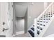 Home foyer with white door, access to basement and staircase with new flooring at 8500 Bowen Ct, Jonesboro, GA 30238