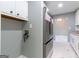 Bright kitchen with stainless steel refrigerator, white cabinetry, and marble tile flooring at 8500 Bowen Ct, Jonesboro, GA 30238