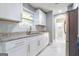 Bright kitchen featuring white cabinets, granite countertops, stainless steel appliances and marble floors at 8500 Bowen Ct, Jonesboro, GA 30238