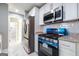 Modern kitchen featuring granite counters, stainless steel appliances, and white cabinetry at 8500 Bowen Ct, Jonesboro, GA 30238
