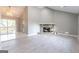 Open-concept living area featuring a stone fireplace, sliding glass door, and seamless access to the kitchen at 8500 Bowen Ct, Jonesboro, GA 30238