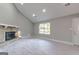 Spacious living room boasts a vaulted ceiling, stone fireplace, recessed lighting and light wood floors at 8500 Bowen Ct, Jonesboro, GA 30238