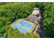 Overhead view of community amenities, including a tennis court, swimming pool, and ample parking, nestled in lush greenery at 1130 S Rudder Rd, Cumming, GA 30041