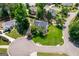 Aerial view of a landscaped home featuring a sprawling green lawn and mature trees, showcasing suburban living at 1130 S Rudder Rd, Cumming, GA 30041