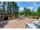 Large wooden deck features a hammock and overlooks a lush backyard setting, perfect for outdoor relaxation at 1130 S Rudder Rd, Cumming, GA 30041