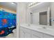 Bathroom with double sink vanity and octopus-themed shower curtain at 1130 S Rudder Rd, Cumming, GA 30041