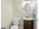 Cozy half bathroom with a decorative mirror and stylish vanity at 1130 S Rudder Rd, Cumming, GA 30041