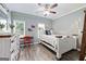 Bedroom featuring hardwood floors, fan, and natural light from the windows at 1130 S Rudder Rd, Cumming, GA 30041