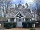 Clubhouse with a nautical theme behind a black metal fence and hedgerow at 1130 S Rudder Rd, Cumming, GA 30041