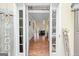 A view into this home with hardwood floors and a view into the home's living spaces and the staircase at 1130 S Rudder Rd, Cumming, GA 30041