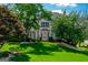 Charming two-story home featuring a well-manicured lawn and mature trees with a bay window at 1130 S Rudder Rd, Cumming, GA 30041