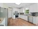 Bright kitchen featuring stainless steel appliances, granite countertops, and white cabinets at 1130 S Rudder Rd, Cumming, GA 30041